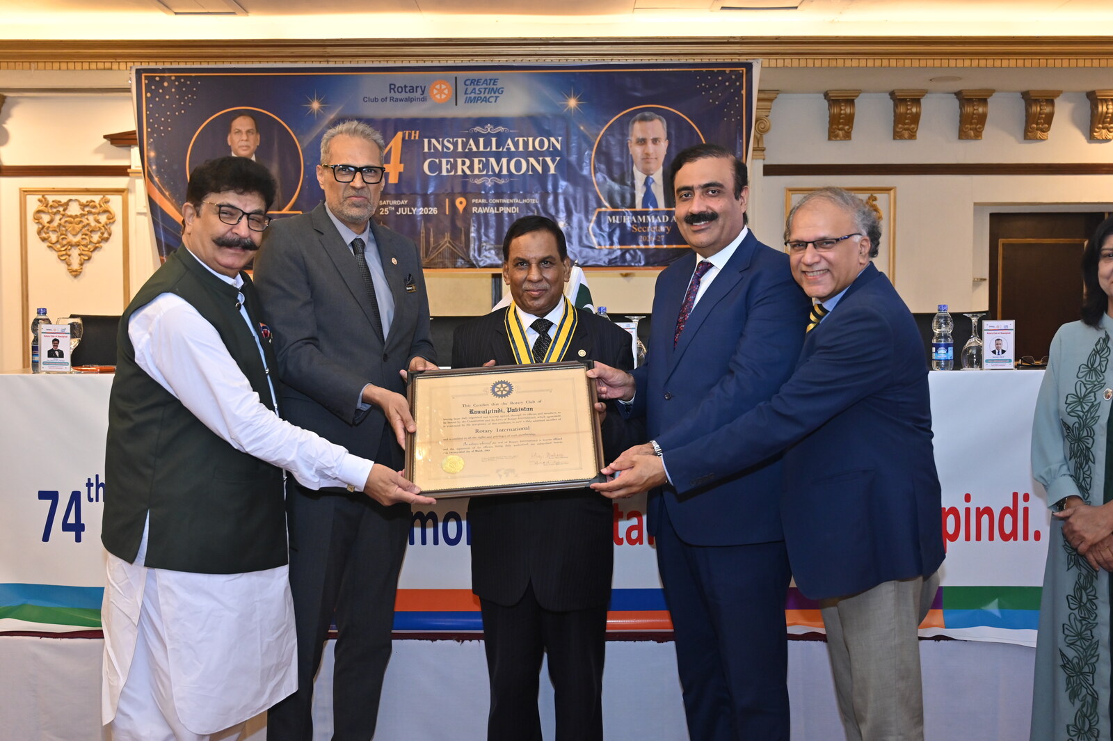 The club charter is presented to the newly installed President of the Rotary Club of Rawalpindi